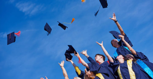 graduates tossing their caps